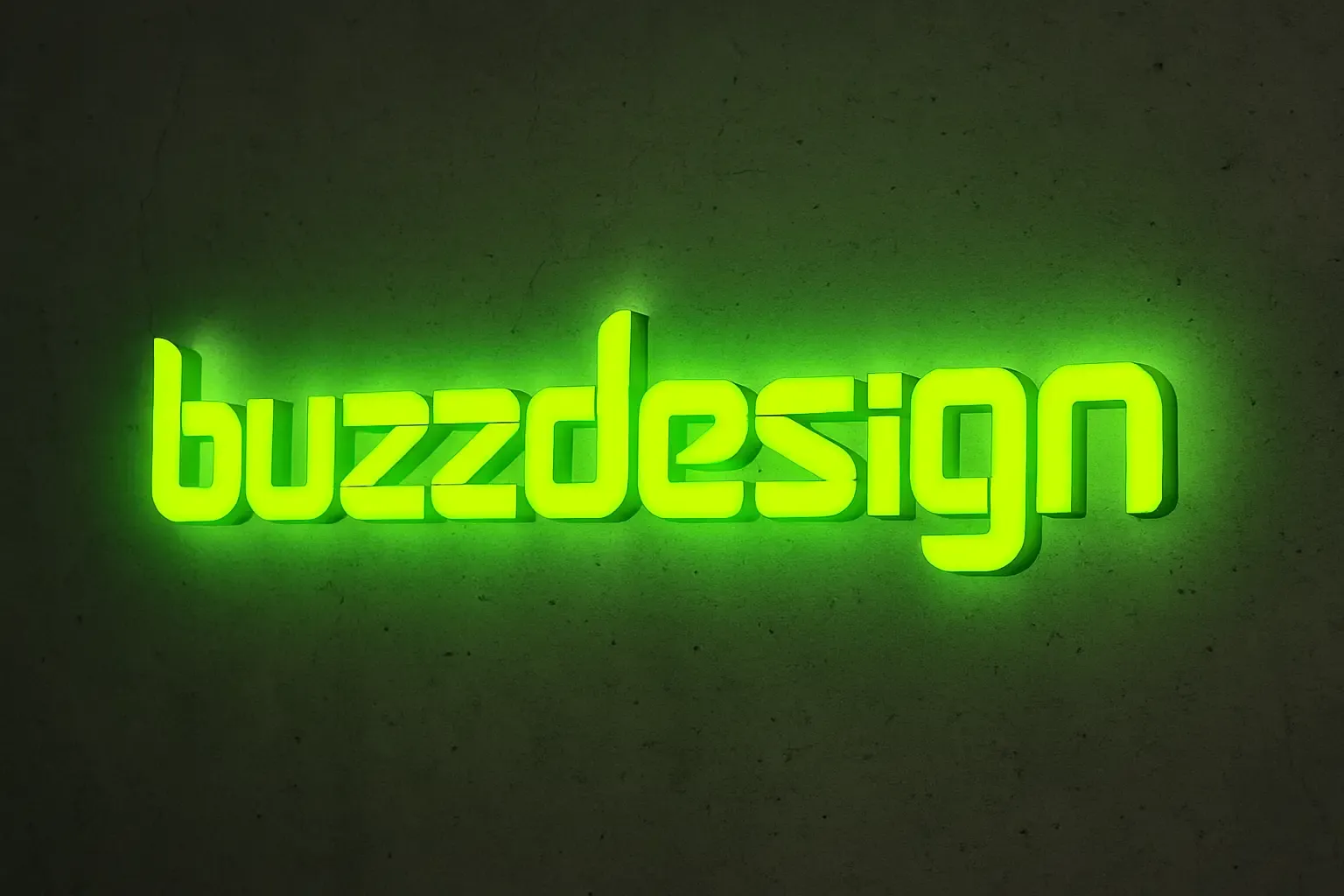 Leuchtende grüne LED-Buchstaben „buzzdesign“